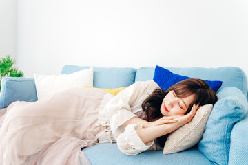 ソファーで仮眠を取る若い女性
