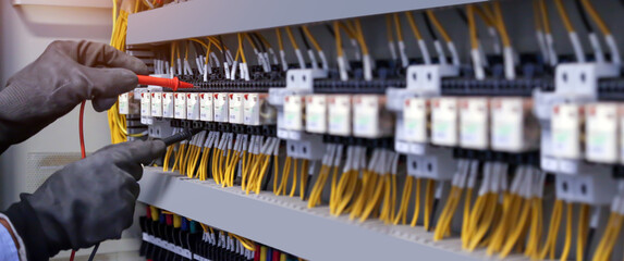 Electricity and electrical maintenance service, Engineer checking electric at circuit breaker and...