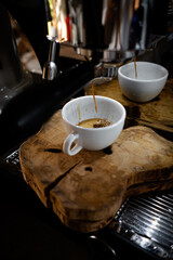 Fresh espresso shot pouring out of machine.