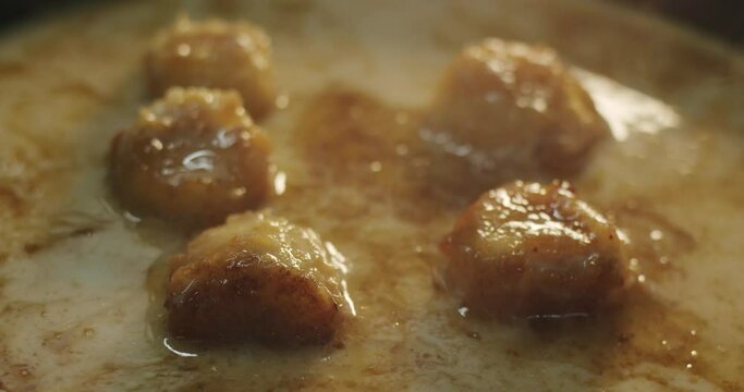 Large banana slices are saut&eacute;ed in hot coconut milk with caramel in slow motion