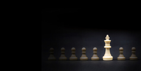 White king chess stand out on dark background, strategy, management or leadership strategy concept