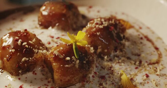 Fragrant walnut grated on top of the delicate mousse dessert with bananas fried in caramel