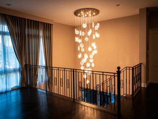 Crystal chandeliers hanging from the ceiling. In the hallway up the stairs