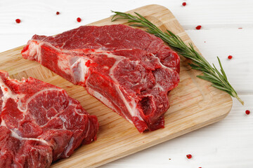 Beef tenderloin on wooden board on wooden table