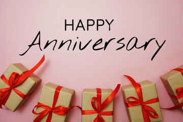 Happy Anniversary typography text with gift boxes on pink background