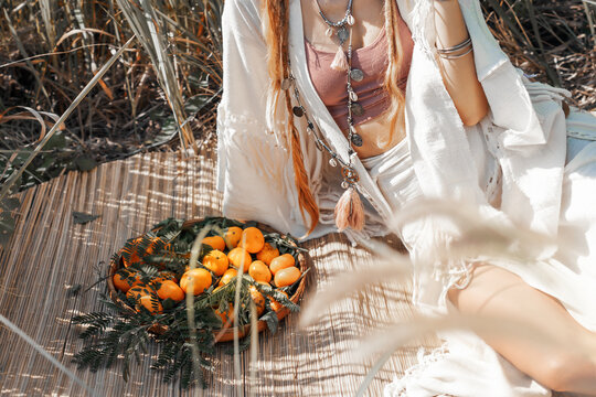 beautiful stylish young woman with fruits at picnic on the field close up