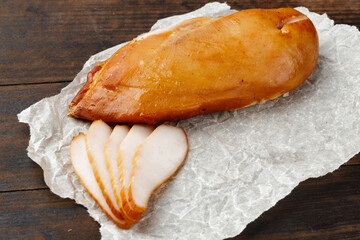 Smoked chicken breast on brown wooden board