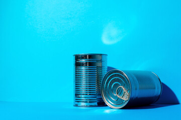 Tin can with food on blue background