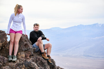 A family with a teenage girl is hiking Dante’s View trail in Death Valley National Park in California, USA during their road trip from Las Vegas to San Francisco in March 2021 during COVID-19 pandemic