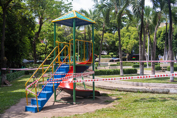 Park kids and children playground for game and activity empty and closed for Coronavirus or Covid19. And strips with word "not allowed area" in Vietnam