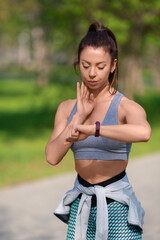 Woman checking her pulse during the race. Vertical photo.