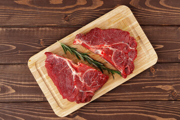 Beef tenderloin on wooden board on wooden table