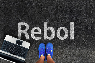 Rebol Programming Language.  Legs in sneakers standing next to laptop and word Rebol
