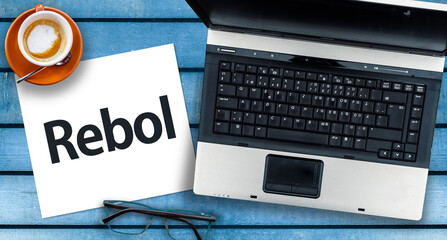 Rebol Programming Language. Word Rebol on paper and laptop 