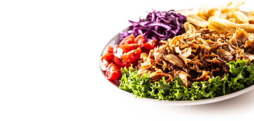 Yummy Turkish chicken kebab prepared and servend on the white plate with lovely homegrown vegetables and salty french fries.