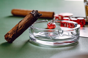 Close up of cigar and red dice cubes, gambling concept