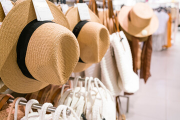 wicker women's hat in a clothing store. summer female image. beach bags and hat for women