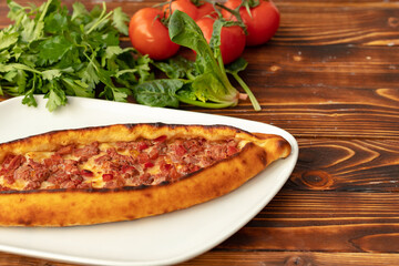 Close up of Turkish Pide bread on wooden table
