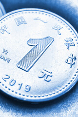 1 one Chinese yuan coin close-up. Light blue tinted vertical illustration about the economy, business, money and finance of PRC. Banking and national currency. Yuan of the new sample of 2019. Macro