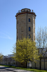Fototapeta na wymiar A brick water tower built in 1904 at the former textile factory, also known as the pressure tower at Augustowska Street in the city of Białystok in Podlasie, Poland.