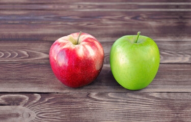 Red and green apple on a wooden background. Two apples