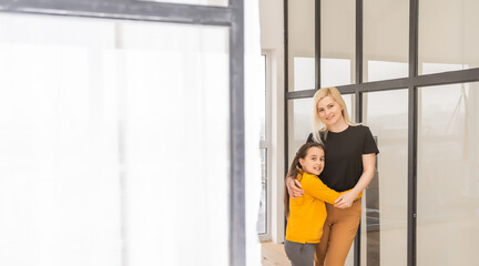 people and family concept, happy smiling girl with mother hugging at home