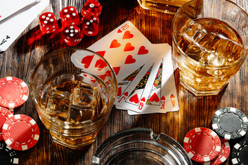 Playing poker with whiskey and cigars on table