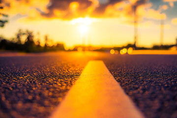 Sunset after rain, the empty highway. Close up view from the level of the solid line