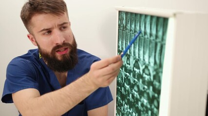 The physiotherapist shows patient an x-ray image of skeleton of bones. Consultation with a doctor.