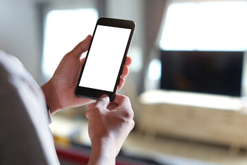 Cropped shot view of man hands holding smart phone with blank copy space screen for your text message or information content, female reading text message on cell telephone during in urban setting. 
