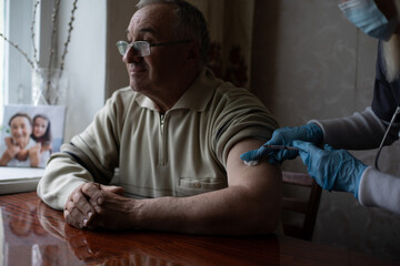 Happy senior man being vaccinated