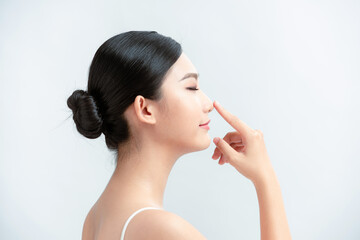 beauty skincare woman smile happily and pointing her nose on white background - obrazy, fototapety, plakaty