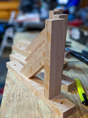 Wooden bracket for mounting on a vertical plane furniture shelves or adjustable systems