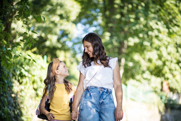 Mother and daughter talking. Mom and kid in nature.