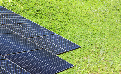 Solar panels installed over green field, the source of renewable and clean energy