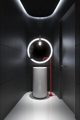 3d render of a minimal atmospheric dark masculine bathroom with a cylindical freestanding washbasin and a red faucet