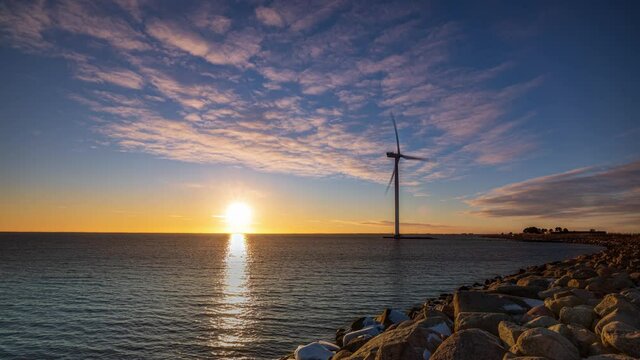 Time Lapse of a modern sea windmill at a colourfull sunset in Denmark