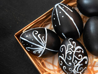 Creative trendy painted easter eggs on black background. Easter ideas. Background with easter eggs