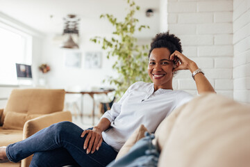 African woman, enjoying at home, alone, posing for camera.