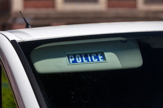 Blue sun visor with written in it "Police".