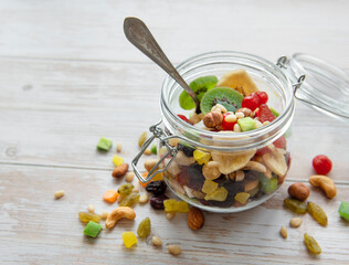 Glass jar with various dried fruits and nuts
