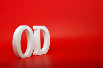OD white letter word wooden Isolated Red Background with Copy Space - Advertise object symbol or ...