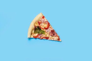 slice of hot fresh pizza lies on a blue background. Top view, flat lay
