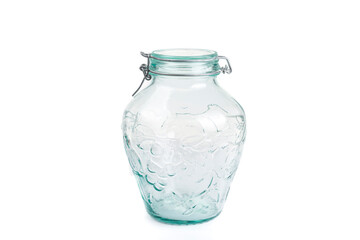 The clear empty jar with a lid on a white