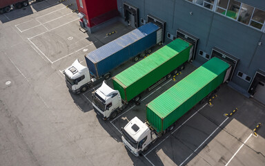 Three trucks loading in the logostics center