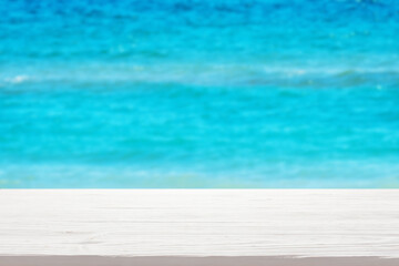 Fototapeta na wymiar White wood table top on blur sea background