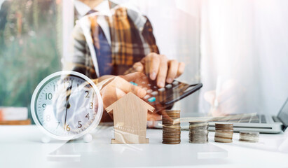 businessman holding coins putting in glass and using calculator. concept saving money and finance accounting.