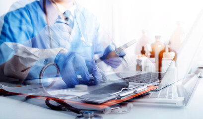 Male doctor sitting at table and writing on a document report in hospital office. Medical healthcare staff and doctor service.