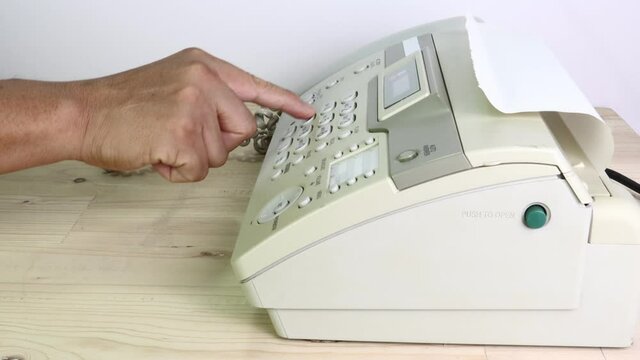 hand man are using a fax machine in the office, equipment for data transmission.