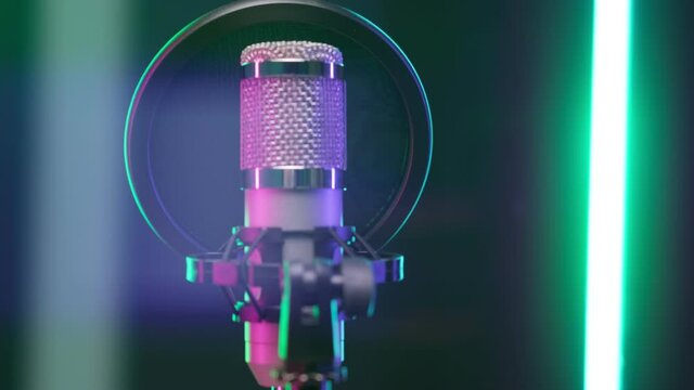 Studio recording, professional microphone in recording studio, close-up. Shooting professional microphone for dubbing and singing in recording studio in rays of colorful floodlights. podcast concept.